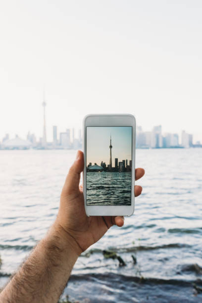 istock Photographing Toronto Skyline at sunset with smartphone 1168982741