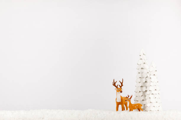 Classic Christmas Reindeer Cartoon Decoration on a Snowy Shelf Classic Christmas Reindeer Cartoon Decoration on a Snowy Shelf. Reindeer family on a white background with ample copy space rudolph the red nosed reindeer photos stock pictures, royalty-free photos & images