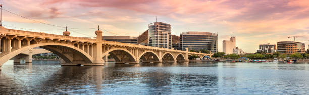 Skyline view panorama of Tempe Arizona and the Mill Avenue bridge Cityscape shore view of downtown Tempe Arizona USA over the Salt River and Mill Avenue Bridge tempe arizona stock pictures, royalty-free photos & images