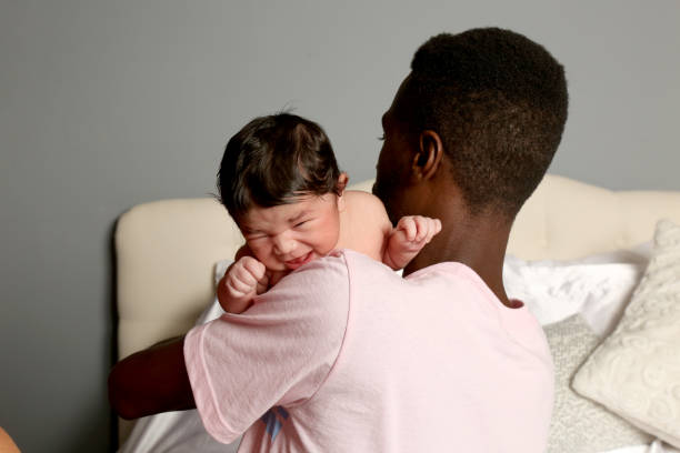 istock First time father holds his newborn daughter for the first time. 1168985259