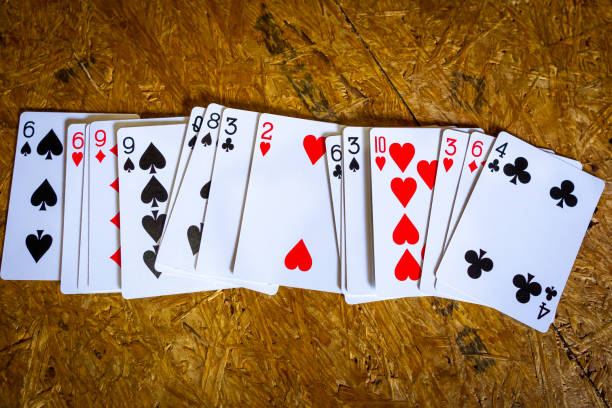 istock Playing Cards Spread On A Wooden Floor 1168985440