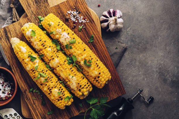 istock Roasted sweet corn with cheese, cilantro and spices on a rustic cutting board. Vegetarian, healthy, clean eating, View from above. 1168986203