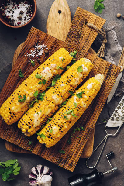 istock Roasted sweet corn with cheese, cilantro and spices on a rustic cutting board. Vegetarian, healthy, clean eating, View from above 1168986206