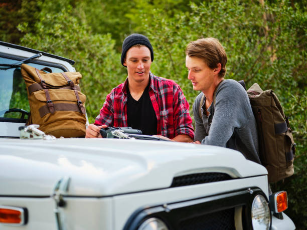 istock Young Men Explorers in the Wilderness with a Vintage 4x4 1168987902