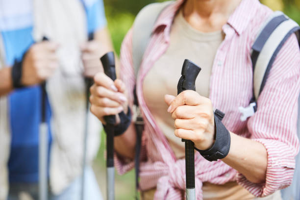 屋外を歩くノルディックウォーキング - nordic walking walking relaxation exercise women ストックフォトと画像