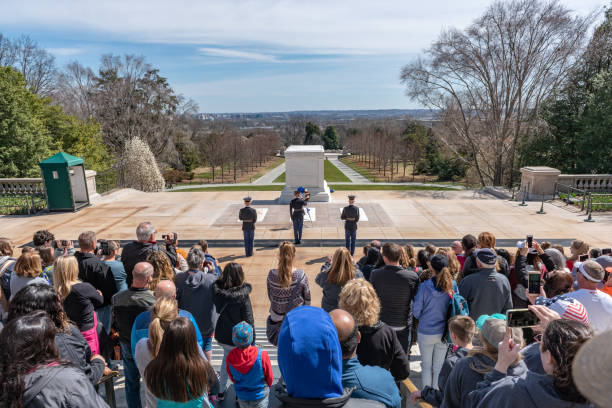 Changing of Guard Ceremony in Arlington National Cemetary during national cherry blossom festival, USA Tourists are watching the Changing of Guard Ceremony.
Arlington National Cemetery gravesite honoring the fallen in wars fought by Americans. arlington cemetery in spring stock pictures, royalty-free photos & images