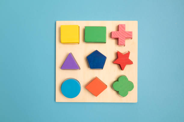 istock Top view Colorful Wooden building blocks with different shapes for developing and entertainment of Children on blue background. 1168991939