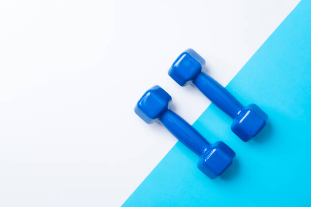 istock Two Dumbbells on a blue and white suface 1168991992