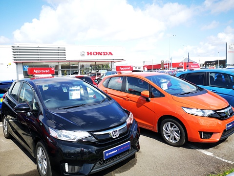 Cardiff, UK: August 19, 2019: Honda Car Dealership with new and used cars on display. Honda Motor Company, Ltd. is a Japanese public multinational conglomerate corporation primarily known as a manufacturer of automobiles, motorcycles, and power equipment.