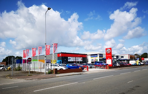 Cardiff, UK: August 19, 2019: M.G. Car Dealership with new and used cars for sale. MG is a British automotive marque and the M.G. Car Company Limited was the British sports car manufacturer that made the marque famous.