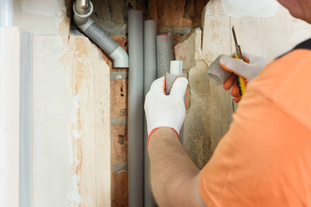 istock Hand with porous pipe insulation. 1168997048