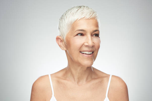 istock Senior woman posing in front of gray background. 1168997059