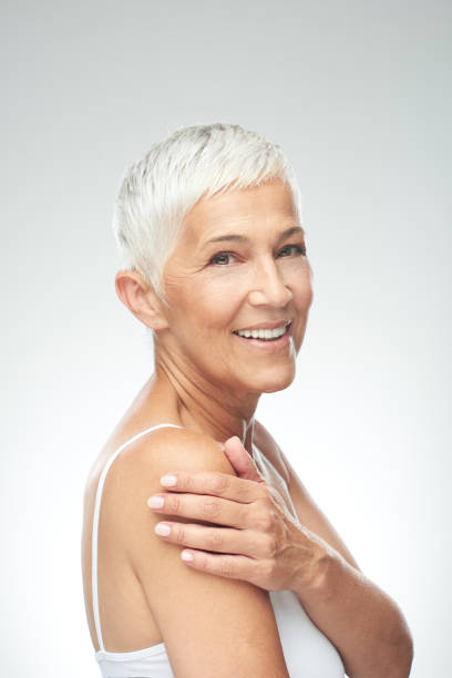 istock Senior woman posing in front of gray background. 1168997106