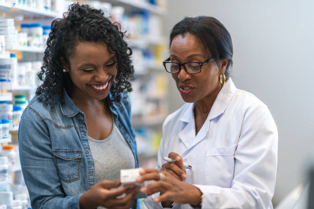 istock Female pharmacist assists woman in pharmacy 1168998464