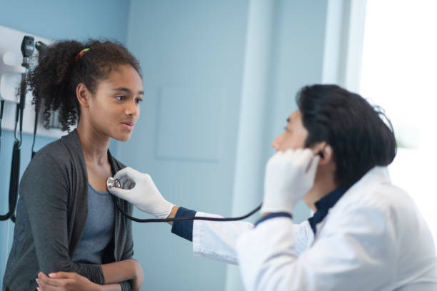 istock Mixed-race elementary age girl has heart checked by doctor 1168998686