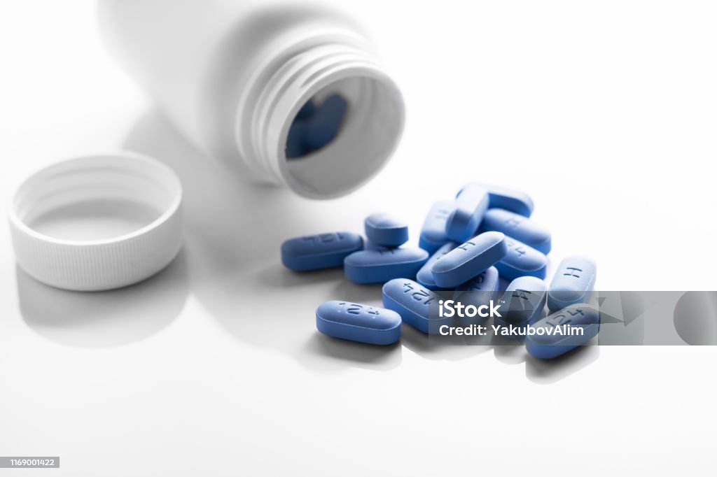 Open bottle of prescription PrEP Pills for Pre-Exposure Prophylaxis to help protect people from HIV. PrEP - Medicine Stock Photo