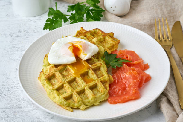 istock Zucchini waffles with salmon and benedict egg, fodmap diet side view closeup 1169003129