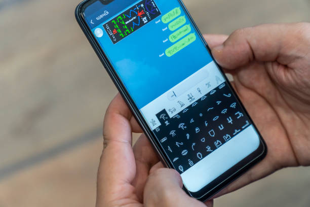 istock Writing alien messages with hieroglyphs on a smartphone 1169005463