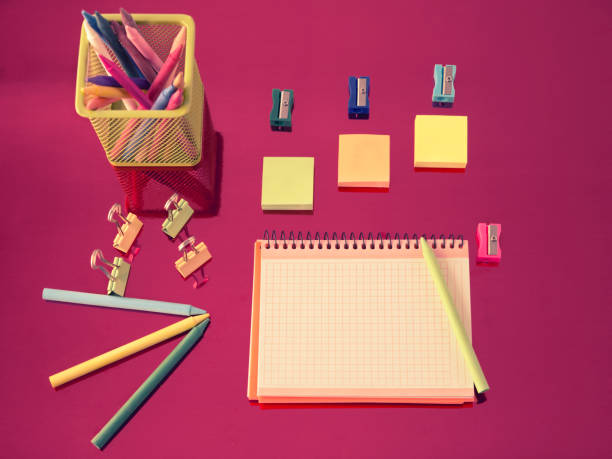 istock blank notebook with supplies school and multicolored pencils on a red background 1169006979