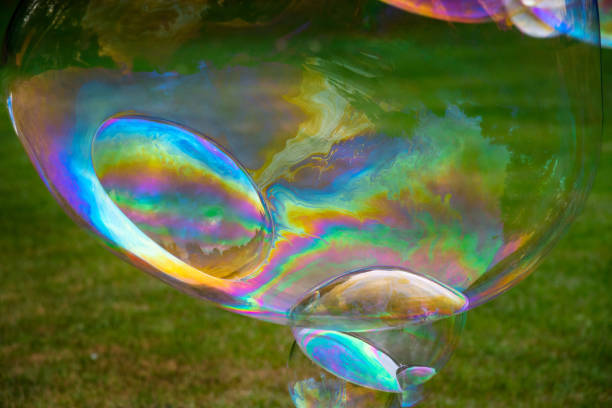 istock giant soap bubbles flying, children playing rainbow 1169009505