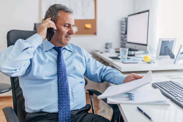istock Senior director having business call 1169011087
