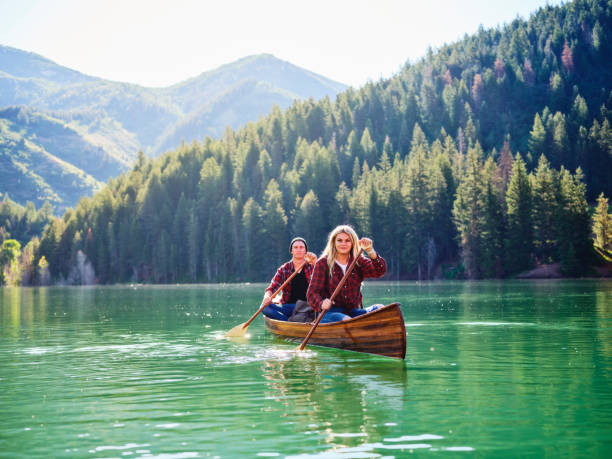 istock Young Couple in a Canoe on a Mountain Lake 1169013146