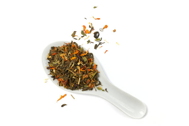 dry herbal tea based on the petals of medicinal plants in spoon on white background - dry tea imagens e fotografias de stock