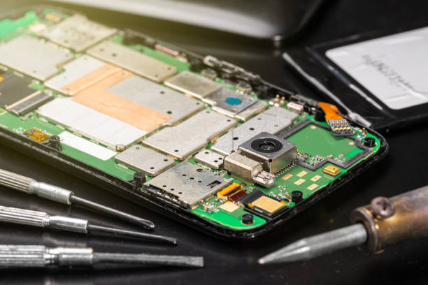 istock Repairing a broken smartphone, open and disassembled closeup macro 1169015439