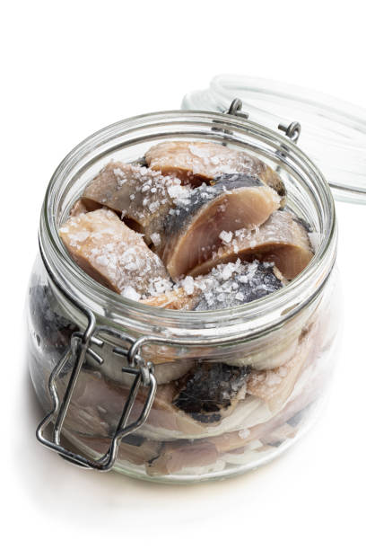 istock Sliced salted herring in glass jar isolated on white 1169016470