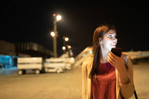 istock Young woman boarding using mobile at airport 1169024983