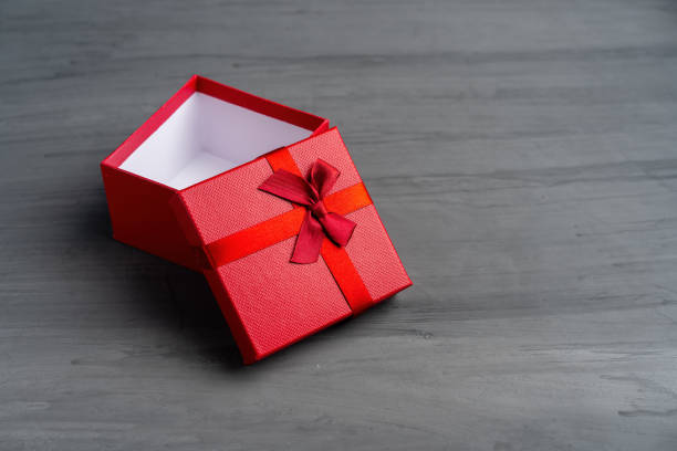 istock Open Red square holiday gift box against a dark background 1169025256