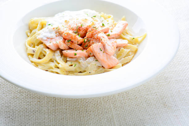 Italian rigatoni pasta with salmon and sour cream. Horizontal shot