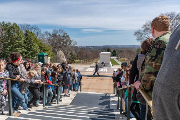 Changing of Guard Ceremony in Arlington National Cemetary during national cherry blossom festival, USA Tourists are watching the Changing of Guard Ceremony.
Arlington National Cemetery gravesite honoring the fallen in wars fought by Americans. arlington cemetery in spring stock pictures, royalty-free photos & images