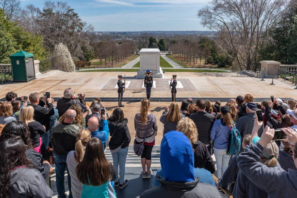 Changing of Guard Ceremony in Arlington National Cemetary during national cherry blossom festival, USA Tourists are watching the Changing of Guard Ceremony.
Arlington National Cemetery gravesite honoring the fallen in wars fought by Americans. arlington cemetery in spring stock pictures, royalty-free photos & images