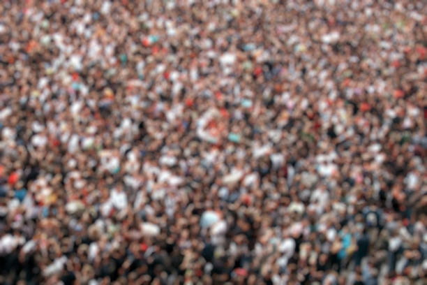 istock Blurred crowd of people in multicolored clothes 1169033061