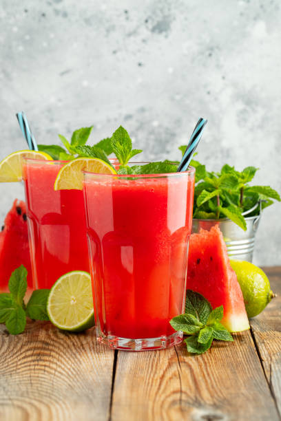 istock Watermelon slushie with lime and mint, summer refreshing drink in tall glasses on a light blue background. Sweet cold smoothie 1169036457