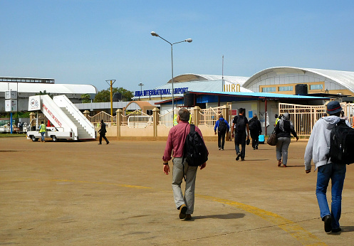 Juba, South Sudan: Juba Airport - passengers walking to the main terminal (IATA: JUB, ICAO: HSSJ)