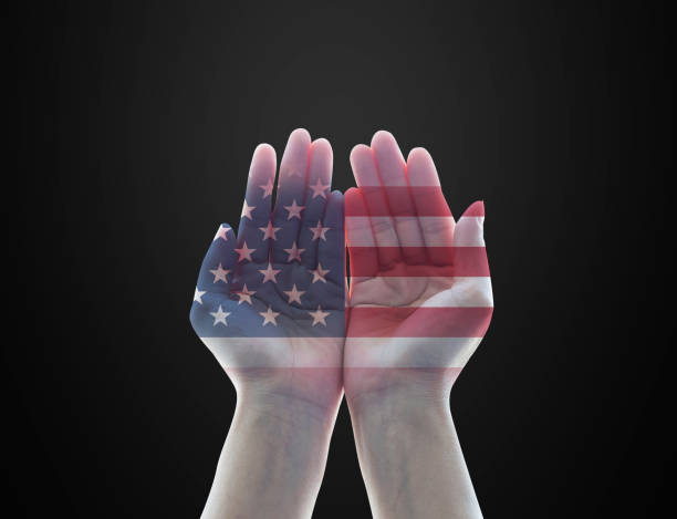 istock America flag pattern on woman's hands with open palms on black background for USA public holiday remembrance concept 1169041189