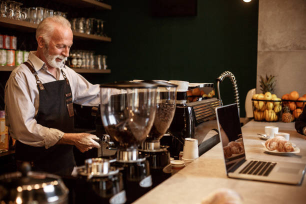 istock Senior barista making espresso 1169041231