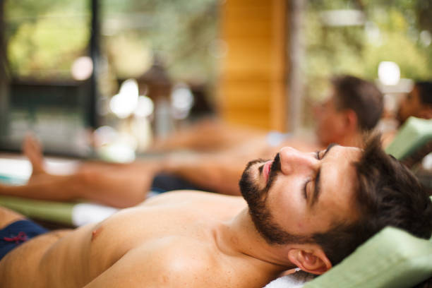 istock Man lying on pool lounge chair 1169041265