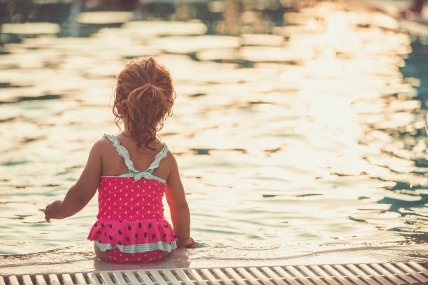 istock Little lady enjoying poolside 1169041375