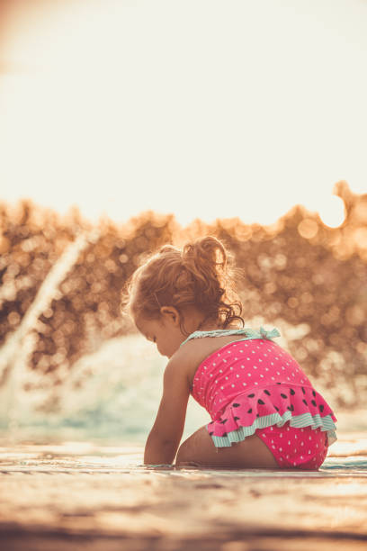 istock Playing in the swimming pool while water is splashing 1169041385