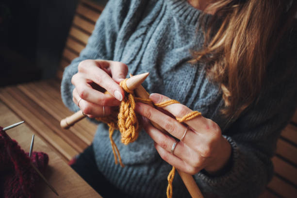 istock Close up on woman's hands knitting 1169041497