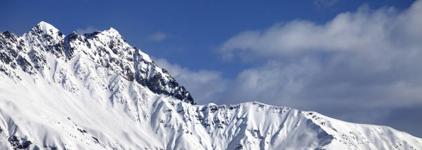 istock Snowy sunlight mountains at nice day 1169041654