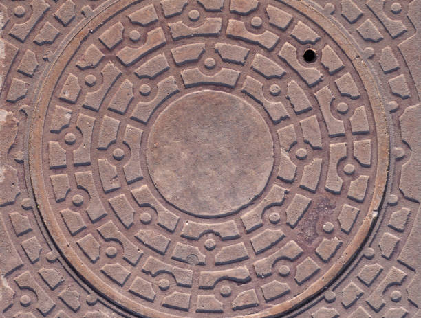 istock sewer iron hatch on the sidewalk. background, texture. 1169046880