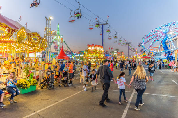 Arizona State Fair at Sunset People throng the midway at the Arizona State Fair in Phoenix during the evening hours. agricultural fair photos stock pictures, royalty-free photos & images