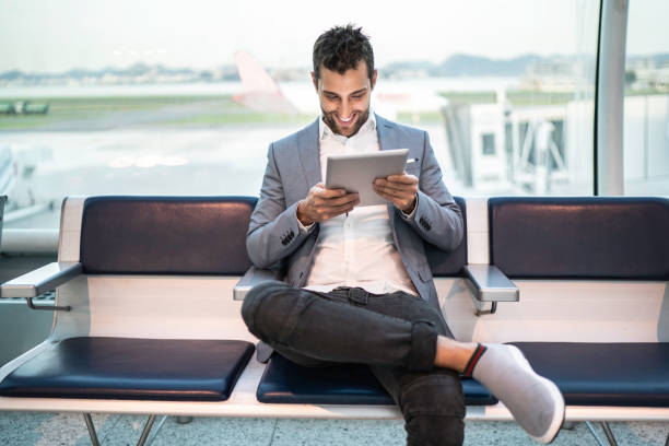 istock Businessman waiting and using tablet on airport 1169053099