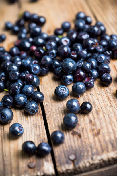 istock Billberries on the rustic wooden background 1169057521