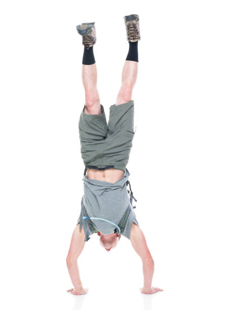 istock Friendly male hiker is doing a handstand 1169061331
