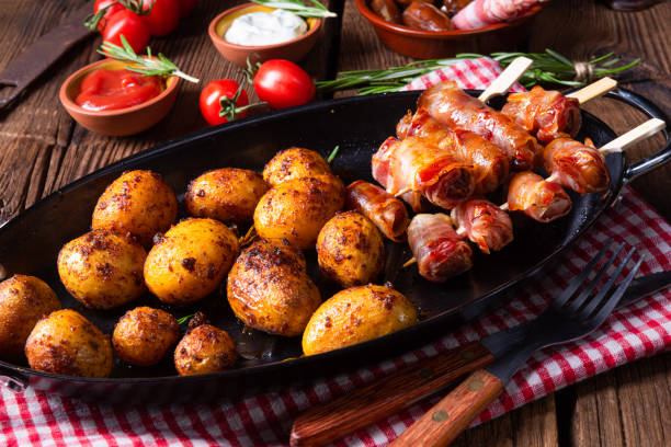 istock Rustic dates wrapped in bacon and young roasted potato. 1169061508